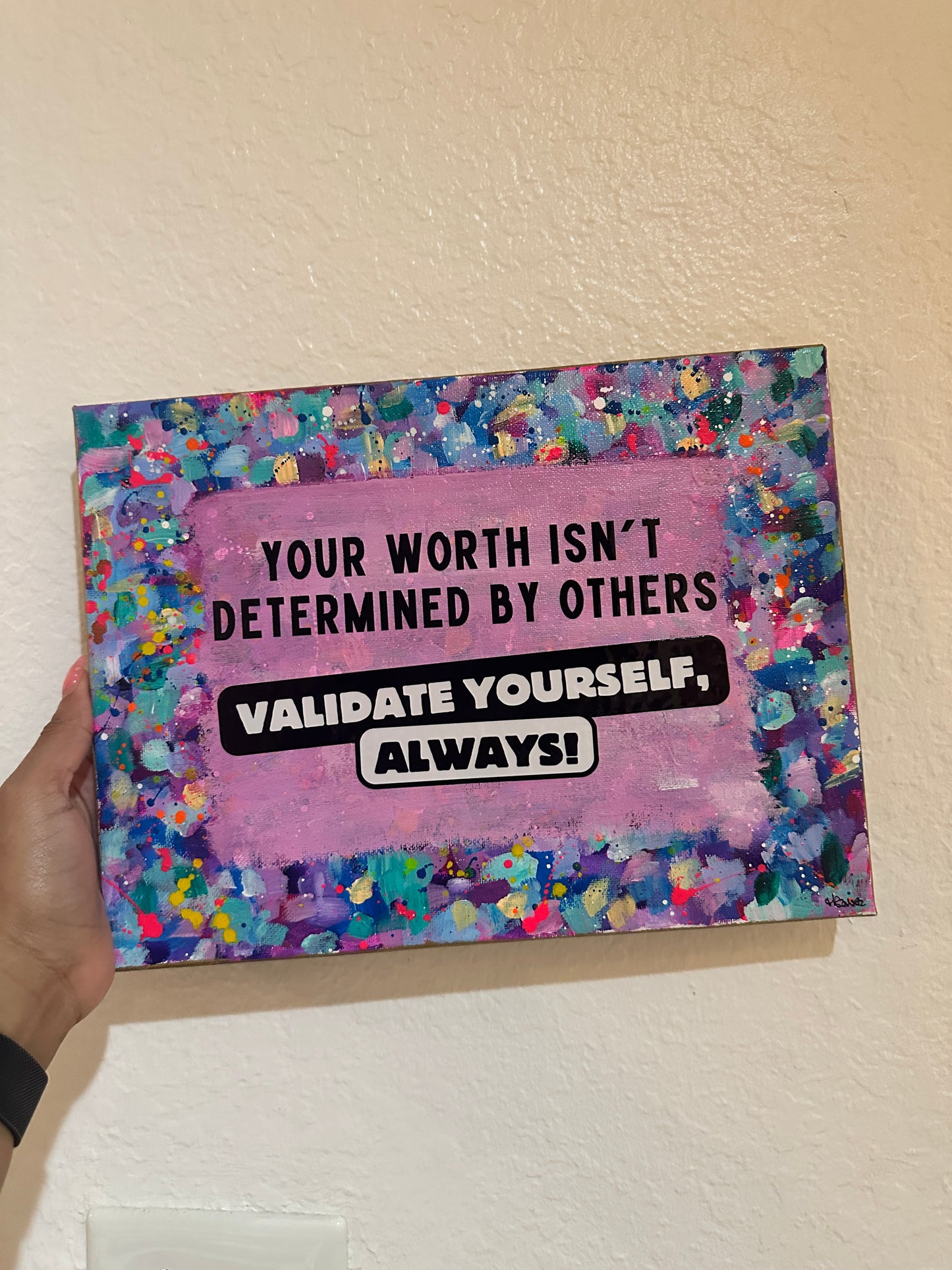 Colorful neon splatter canvas with bold black text “Your worth isn’t determined by others – Validate yourself, always!”