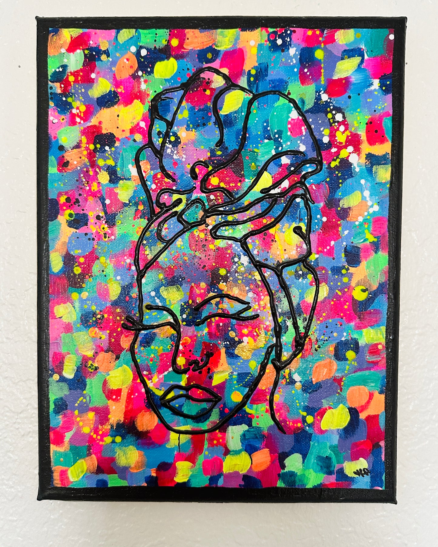 Brightly colored splatter-paint canvas featuring a black continuous-line side-profile portrait of a woman's face