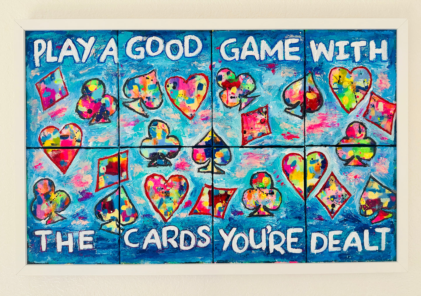 Eight-panel abstract canvas set titled “Play a Good Game,” featuring bold colorful brushstrokes mixed with oversized playing card suit symbols, conveying resilience and motivation.