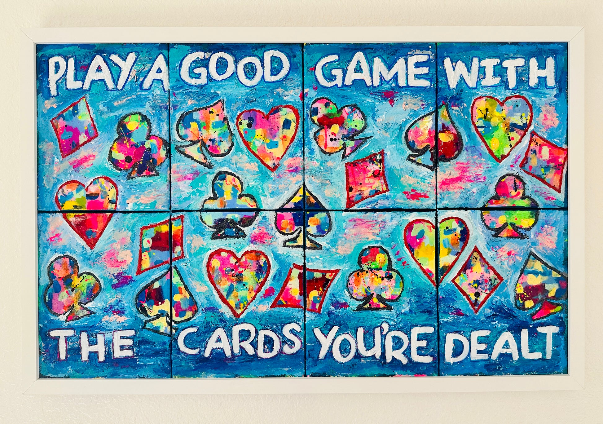 Eight-panel abstract canvas set titled “Play a Good Game,” featuring bold colorful brushstrokes mixed with oversized playing card suit symbols, conveying resilience and motivation.
